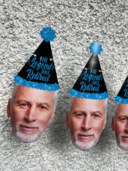 older man wearing a black and blue glitter party hat that reads "The legend Has Retired"
