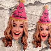 blond woman wearing a pink party hat that says "40 and fabulous!" hanging on a string against a brick wall