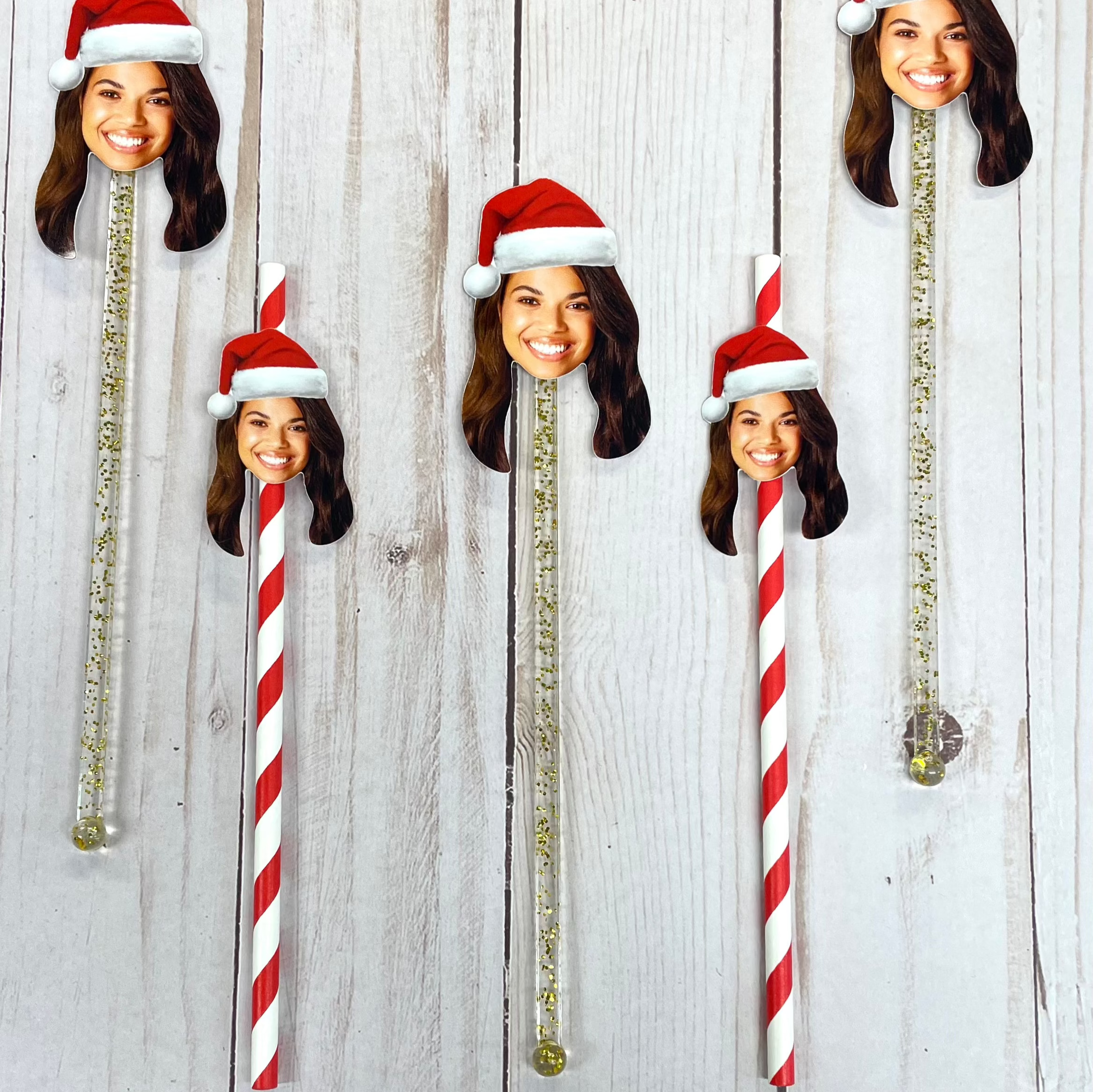 red and gold straws and stir sticks with a woman wearing a santa hat
