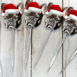 Cut out a french bulldogs face wearing a santa hat stuck on clear cocktail picks