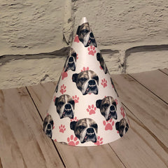 a paw print party hat with a bulldogs face scattered over it displayed on a table