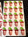 christmas sticker sheer of a mans face cut out wearing a red and green elf hat