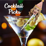 blond woman wearing a glitter pink party hat on a clear cocktail pick stuck in a cocktail glass with olives