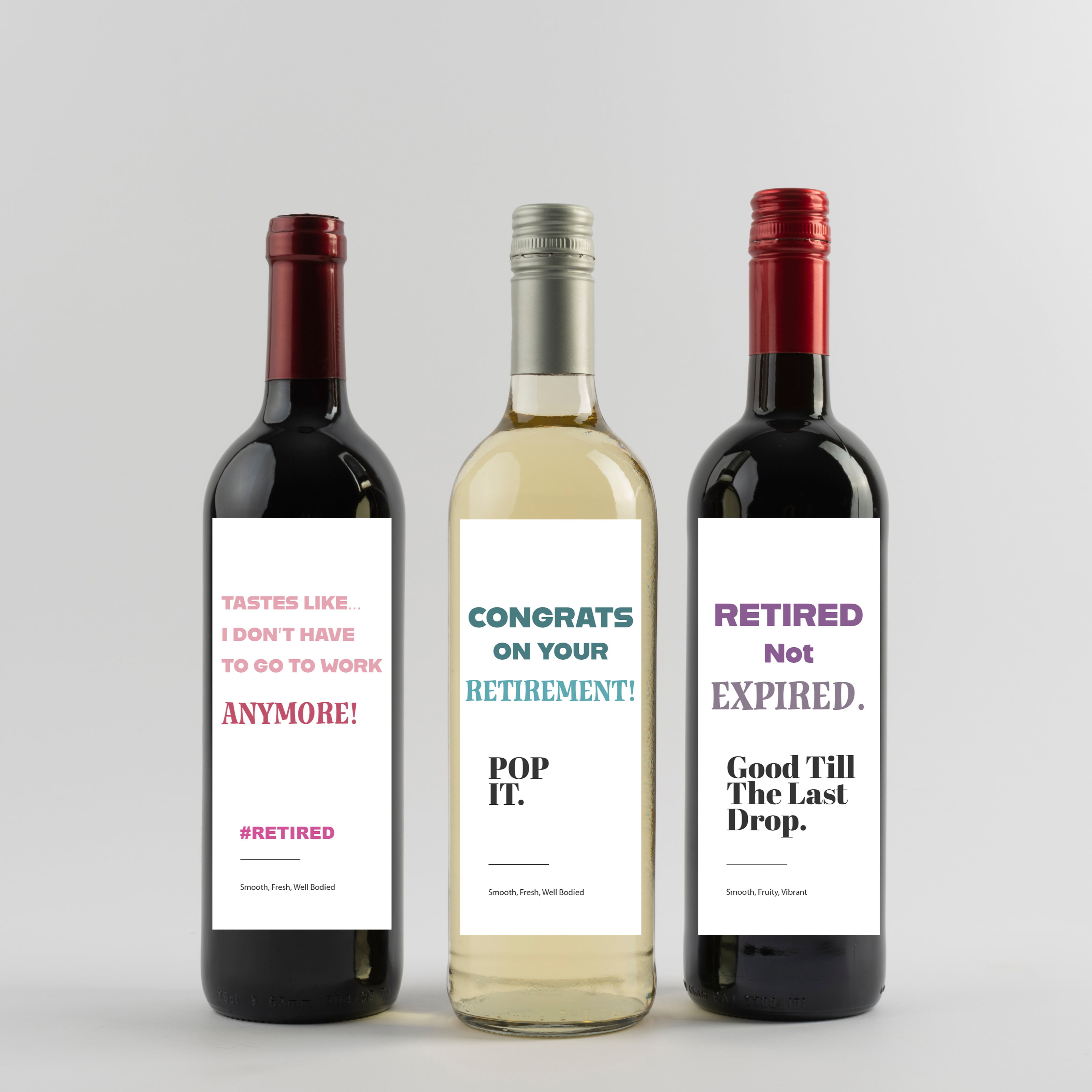 Three wine bottles with humorous labels on a light gray background