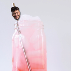 Person with a pink and white gradient bottle on a light gray background
