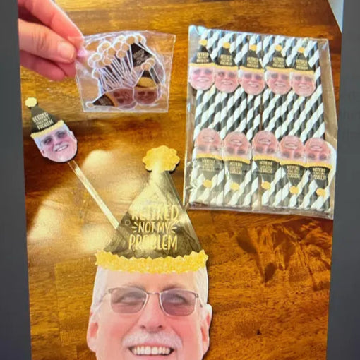 Set of custom retirement face decorations on a table including confetti, straws, drink stir sticks and a face banner