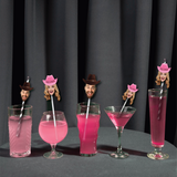 custom face photo drink accessories in a variety of cups on a black table with a black curtain background
