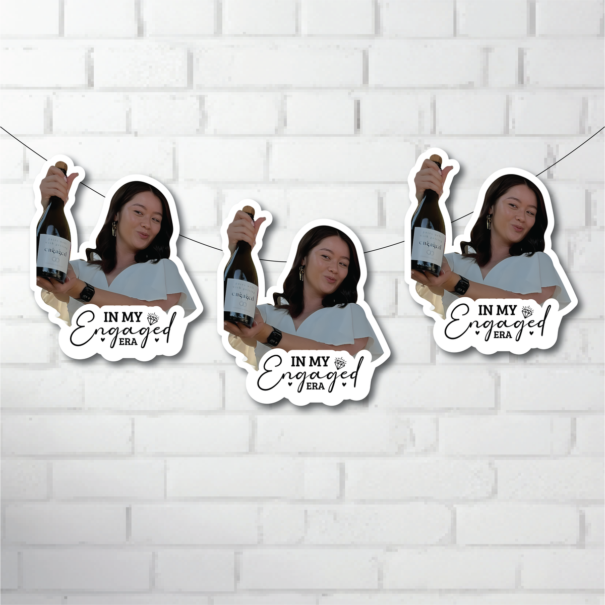 Three cut outs of a person holding a bottle with 'In My Engaged Era' text on a white brick wall background.