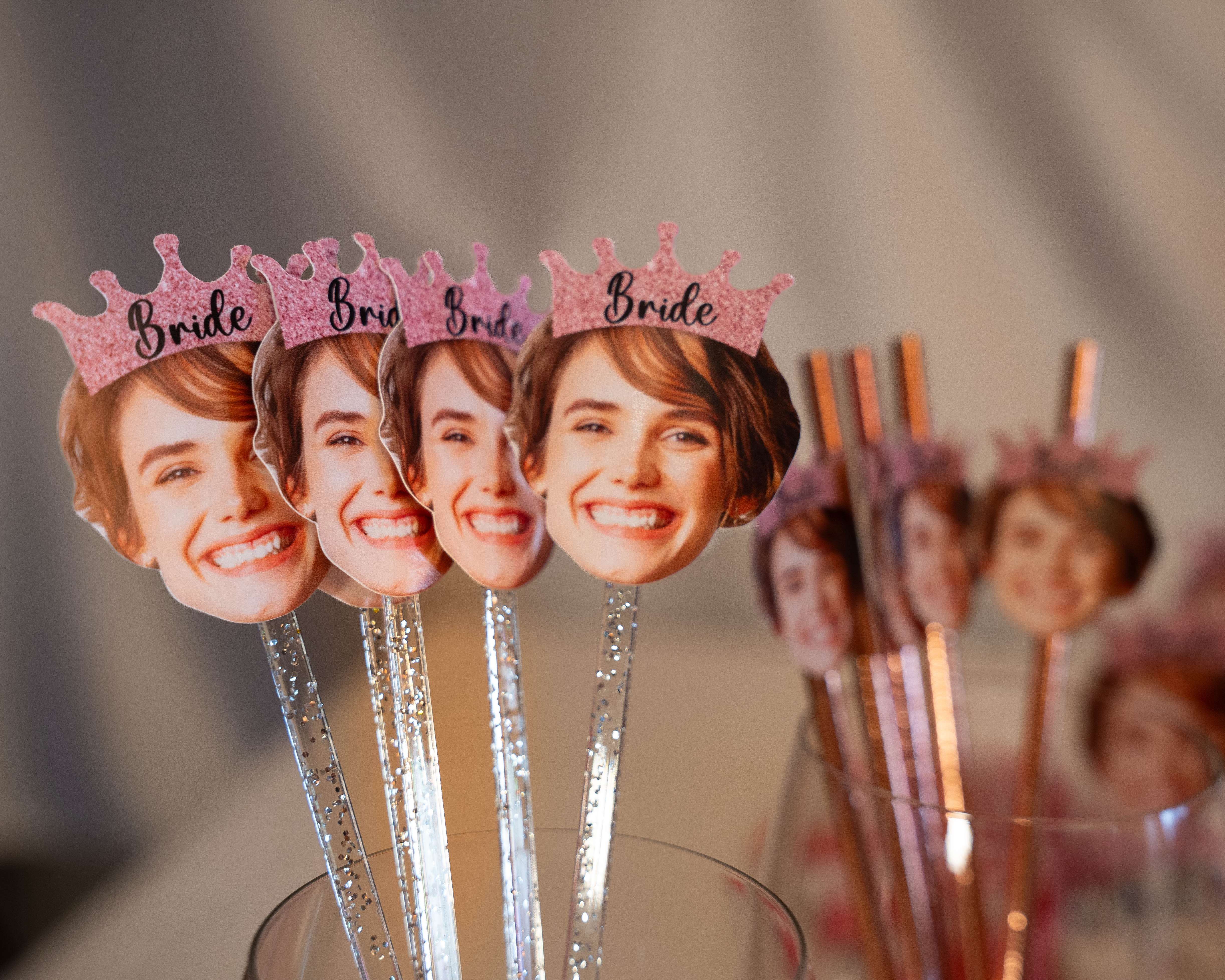Cupcake toppers with 'Bride' text and pink crowns on a blurred background