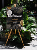 a sign reading "Welcome to Tommy's Retirement Party" with black balloons 