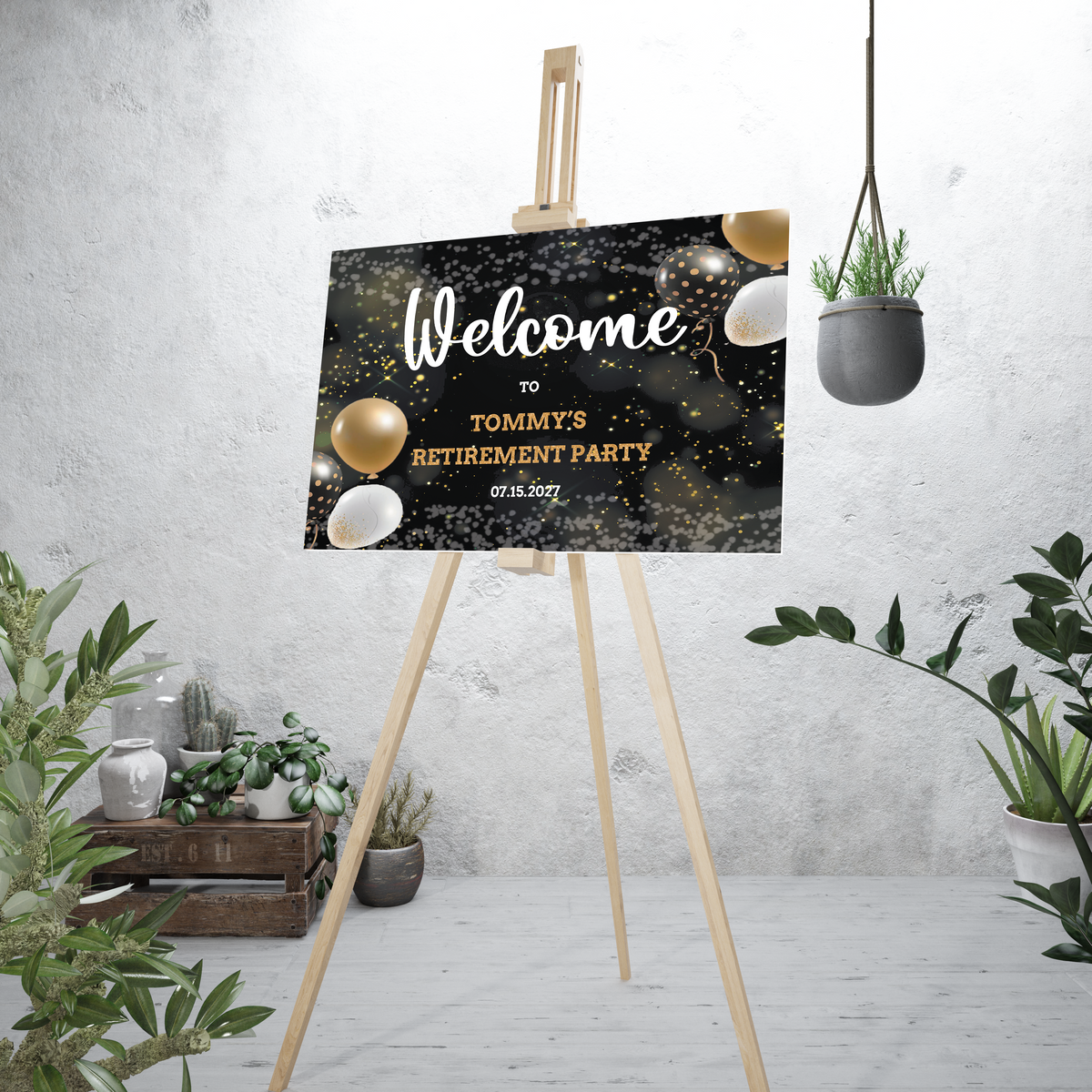 a sign reading "Welcome to Tommy's Retirement Party" with black and gold balloons on an easle with plants in the background