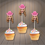 cupcake toppers on cupcakes of a woman wearing a pink cowgirl hat on a wooden background