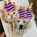 Dog cupcake topper at a birthday party with paw print decorations