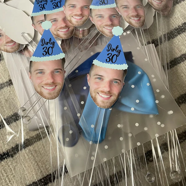 cut out of a mans face wearing a blue party hat that says "Dirty 30"