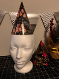 a custom happy new year party hat on a mannequin head displayed on a table