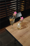 custom face photo cocktail pick with pink cowgirl hats in glasses on a wooden table in a restaurant