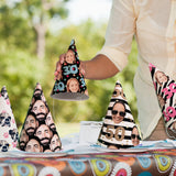 A variety of colorful party hats featuring different face patterns displayed on a table